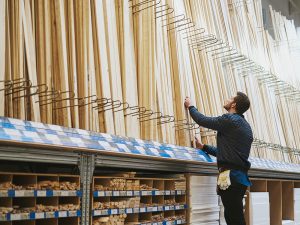 man choosing lumber at home center